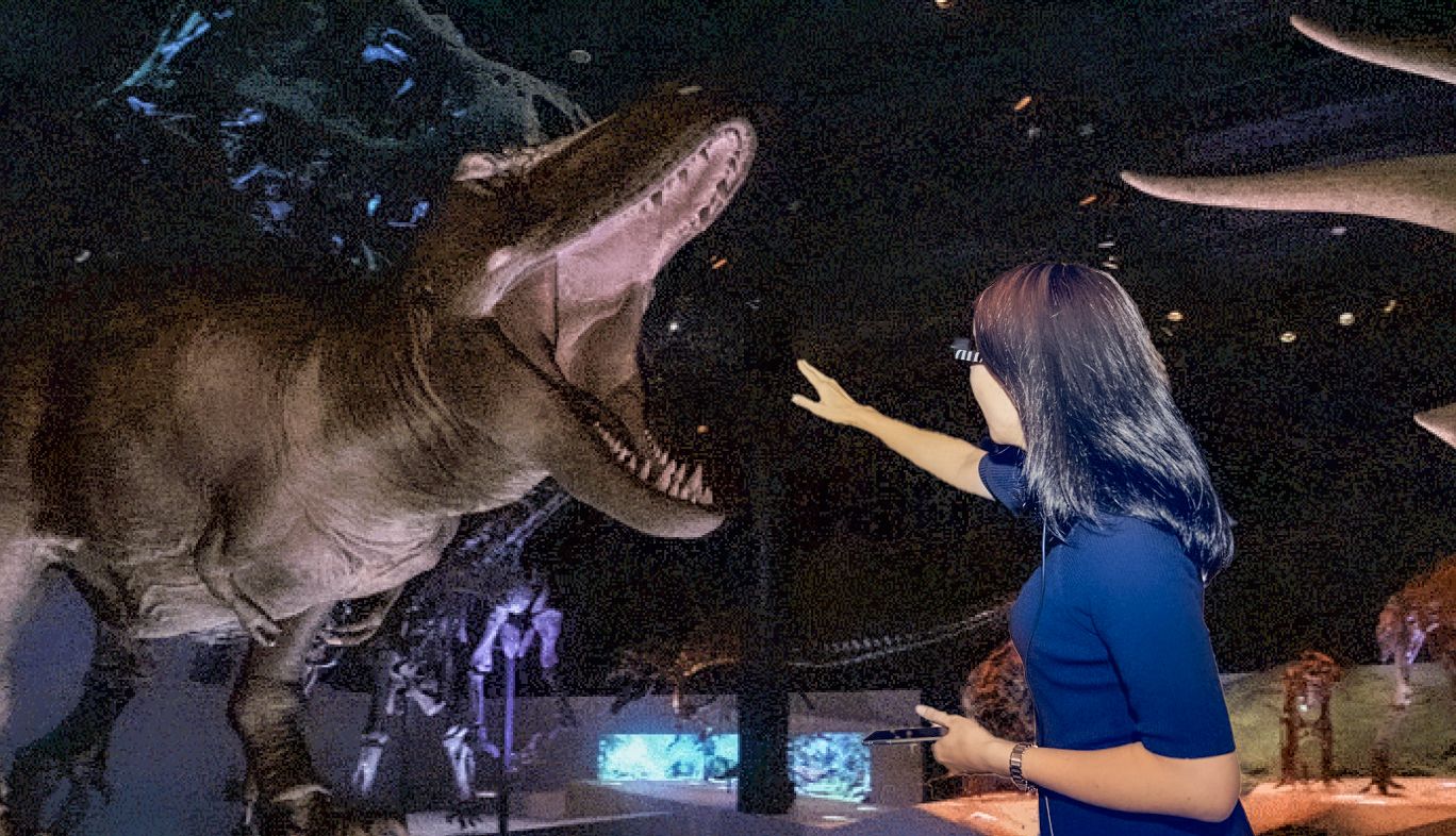 DinoScience 恐竜科学博の展示コーナーで体験できる、最新AR技術とスマートグラスで再現される「au 5Gで恐竜がよみがえる！スマートグラスをかけてAR体験」